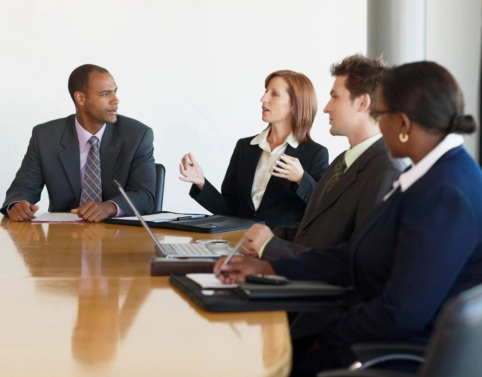 A group of people sitting at a table.